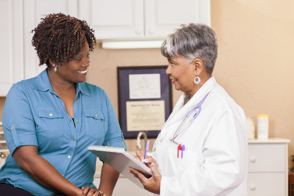 Doctor Conducts Medical Consultation With Adult Patient At Clinic Harbor Health Services 2675
